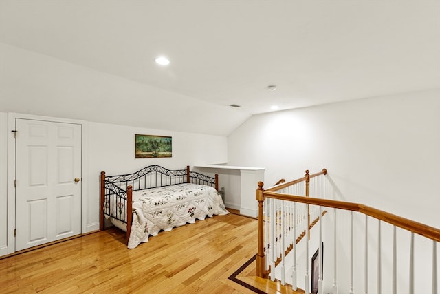 bedroom featuring light hardwood / wood-style floors and vaulted ceiling