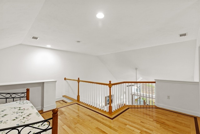 bedroom with lofted ceiling and hardwood / wood-style flooring