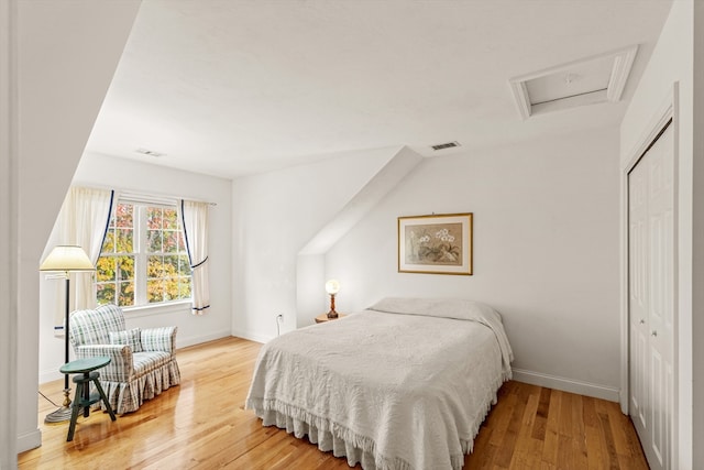 bedroom with hardwood / wood-style floors and a closet