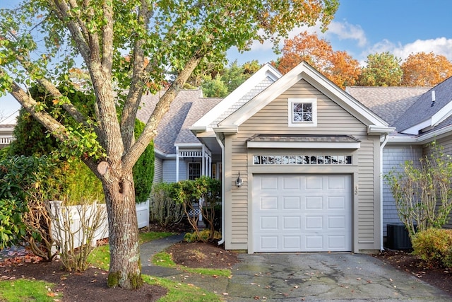 view of front of property featuring a garage and central AC unit