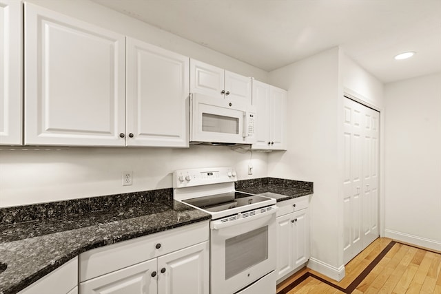 kitchen with white cabinets, light hardwood / wood-style flooring, and white appliances