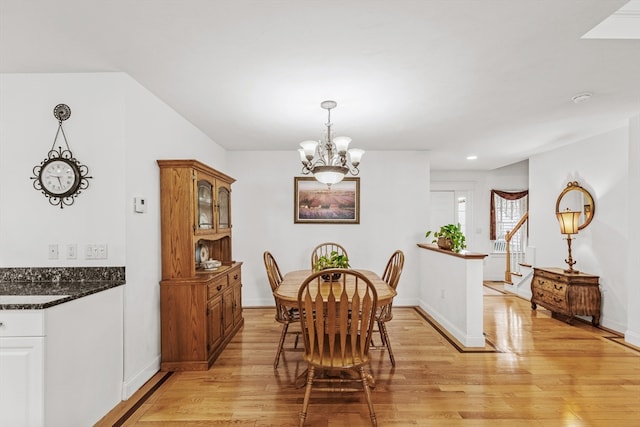 dining room with a chandelier and light wood-type flooring