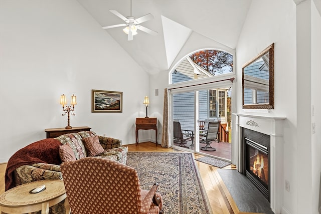 living room with high vaulted ceiling, light wood-type flooring, and ceiling fan