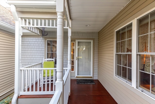 view of exterior entry featuring covered porch