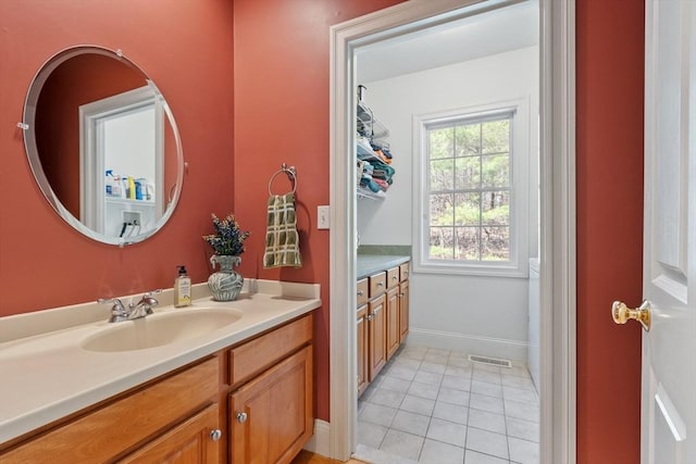bathroom featuring vanity, tile patterned floors, and baseboards
