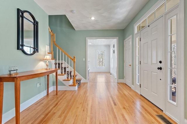 entryway with stairs, wood finished floors, baseboards, and recessed lighting