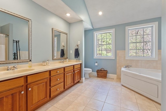 full bathroom with double vanity, tile patterned flooring, a garden tub, toilet, and vaulted ceiling
