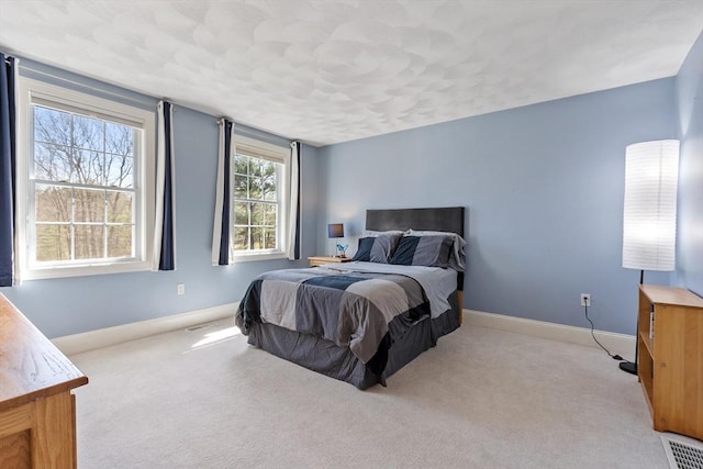 carpeted bedroom with baseboards