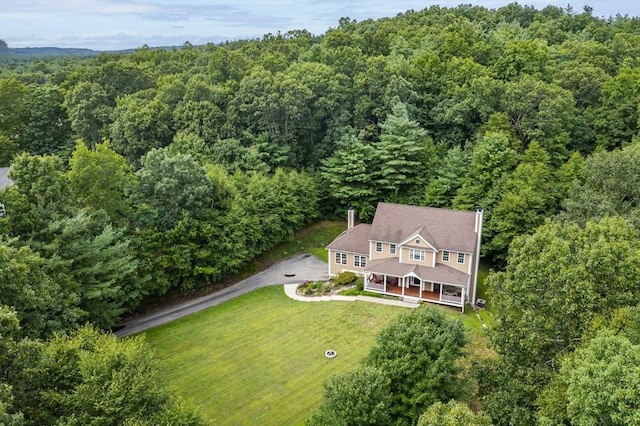 view of subject property featuring a forest