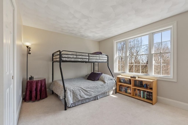 bedroom with carpet and baseboards