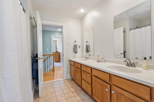 bathroom featuring double vanity, tile patterned floors, and recessed lighting