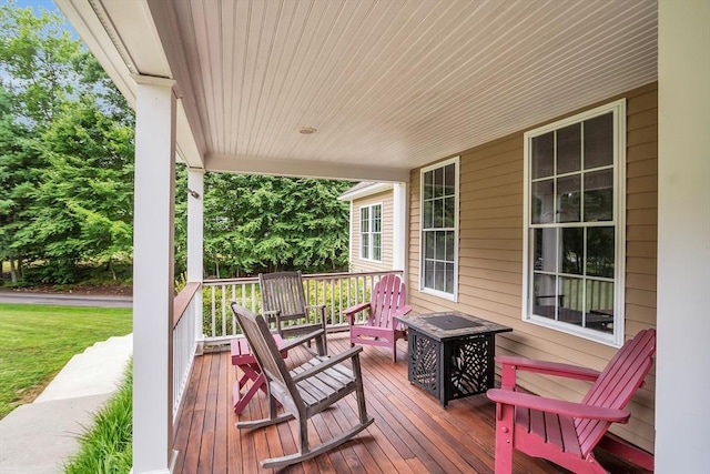 deck featuring a porch and a fire pit