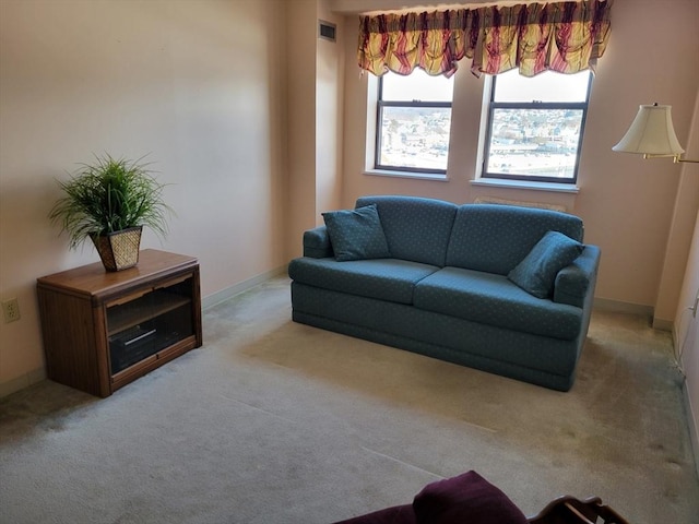 living area with visible vents, baseboards, and carpet flooring