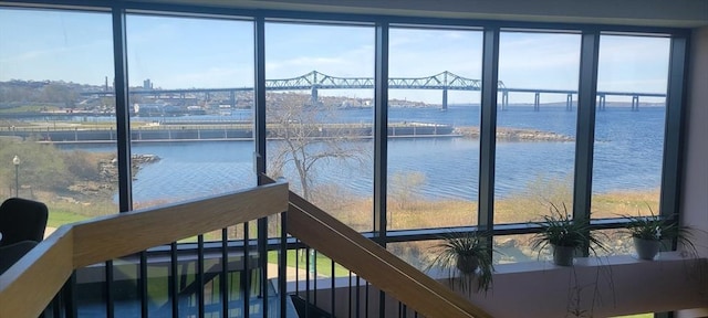 interior space with stairs and a water view