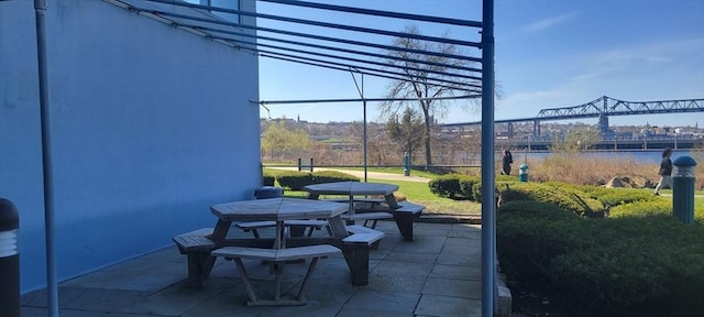 view of patio / terrace with a water view and outdoor dining space