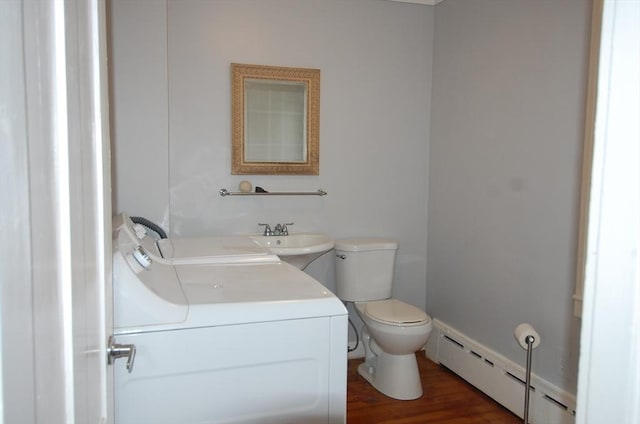 bathroom featuring a baseboard radiator, vanity, toilet, and wood finished floors