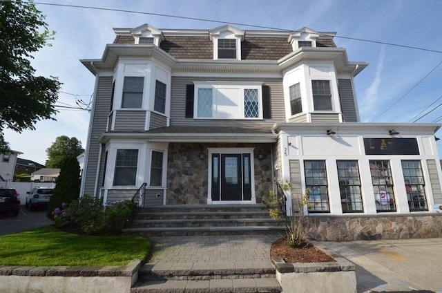 75 Pine St Unit 21, Waltham, MA 02453 - second empire-style home with stone siding, entry steps, and mansard roof