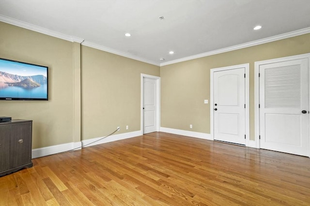75 Pine St Unit 21, Waltham, MA 02453 - unfurnished living room featuring light wood-style floors, ornamental molding, recessed lighting, and baseboards