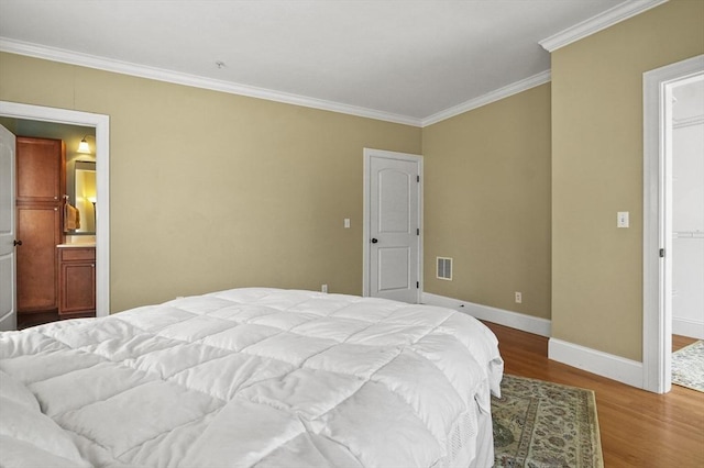 75 Pine St Unit 21, Waltham, MA 02453 - bedroom featuring crown molding, wood finished floors, baseboards, and ensuite bath