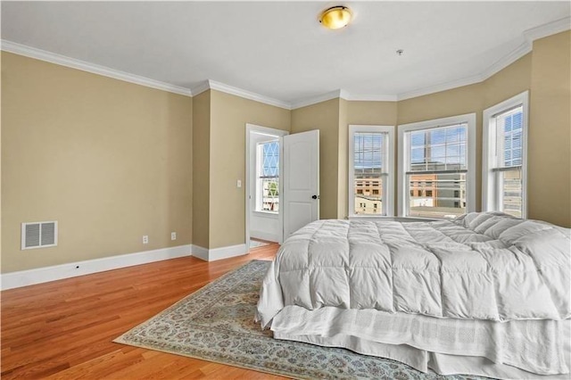 75 Pine St Unit 21, Waltham, MA 02453 - bedroom with baseboards, wood finished floors, and crown molding