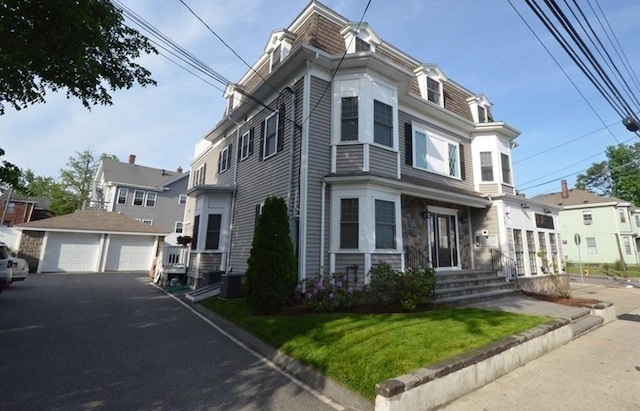 75 Pine St Unit 21, Waltham, MA 02453 - victorian home featuring a garage, an outdoor structure, mansard roof, and central AC