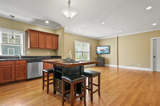 75 Pine St Unit 21, Waltham, MA 02453 - kitchen featuring stainless steel dishwasher, dark countertops, crown molding, a sink, and pendant lighting
