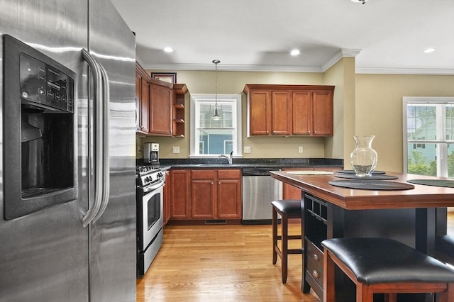 75 Pine St Unit 21, Waltham, MA 02453 - kitchen with stainless steel appliances, open shelves, ornamental molding, decorative light fixtures, and light wood-style flooring