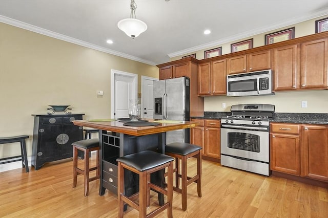 75 Pine St Unit 21, Waltham, MA 02453 - kitchen featuring stainless steel appliances, crown molding, brown cabinetry, light wood finished floors, and recessed lighting
