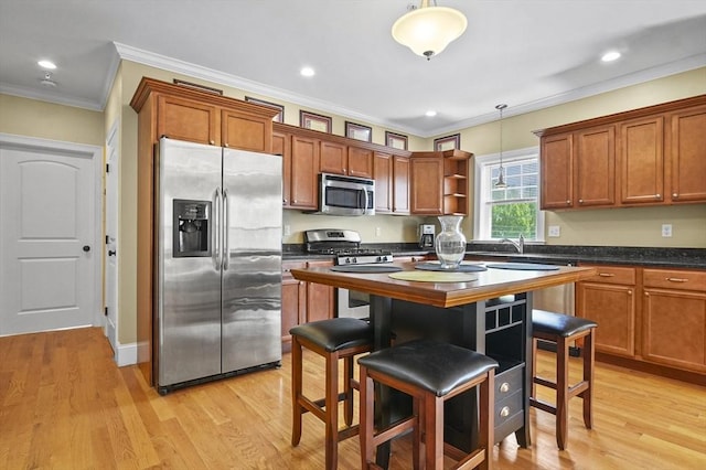 75 Pine St Unit 21, Waltham, MA 02453 - kitchen featuring appliances with stainless steel finishes, open shelves, dark countertops, decorative light fixtures, and crown molding