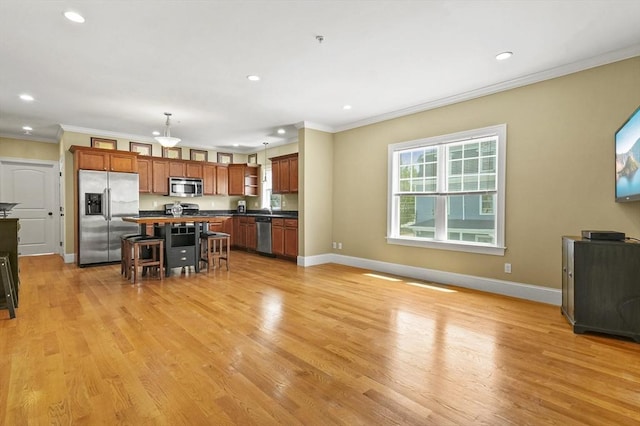75 Pine St Unit 21, Waltham, MA 02453 - kitchen featuring stainless steel appliances, dark countertops, recessed lighting, a kitchen bar, and ornamental molding
