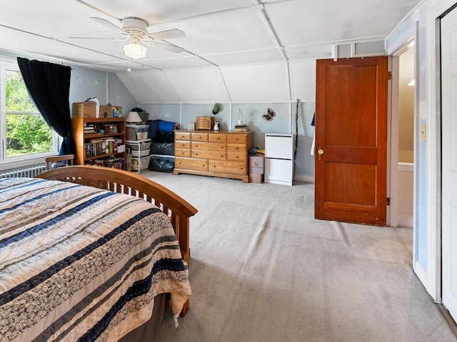 bedroom featuring light colored carpet and lofted ceiling