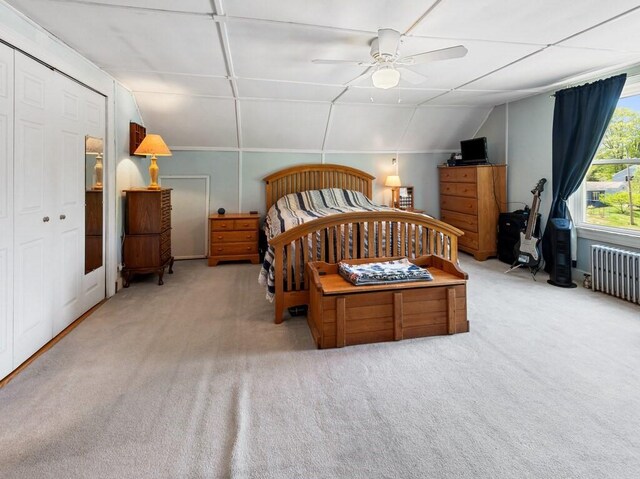 bedroom with radiator heating unit, light carpet, lofted ceiling, and ceiling fan