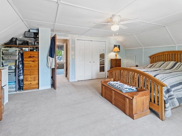 carpeted bedroom with vaulted ceiling, a closet, radiator heating unit, and a ceiling fan