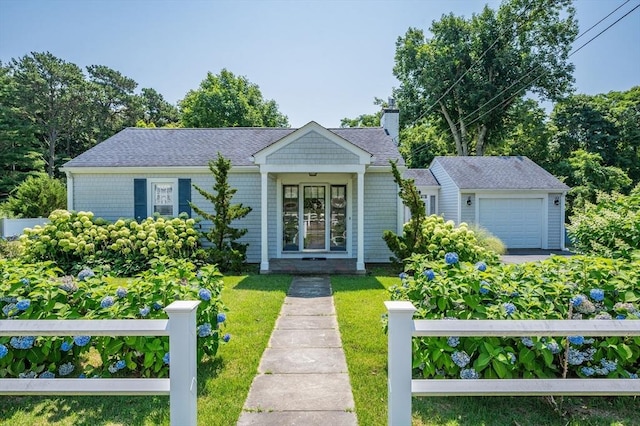 46 Pine, Falmouth, MA 02556 - view of front of home with a chimney, a front yard, and an attached garage