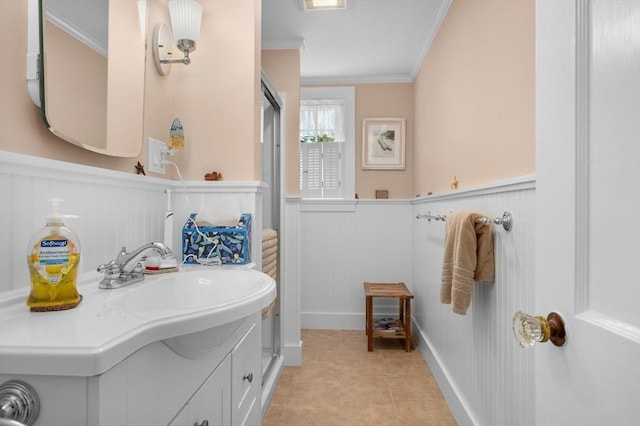 46 Pine, Falmouth, MA 02556 - bathroom with wainscoting, ornamental molding, a decorative wall, vanity, and tile patterned floors