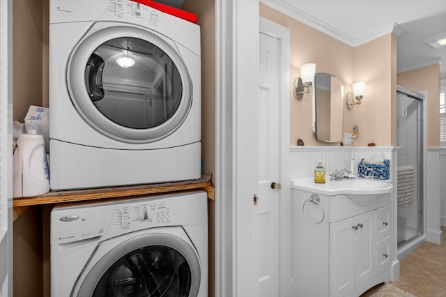 46 Pine, Falmouth, MA 02556 - washroom with stacked washer and clothes dryer, crown molding, and a wainscoted wall
