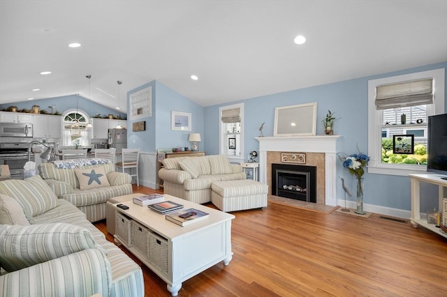 46 Pine, Falmouth, MA 02556 - living room featuring lofted ceiling, a tiled fireplace, light wood-style flooring, recessed lighting, and baseboards