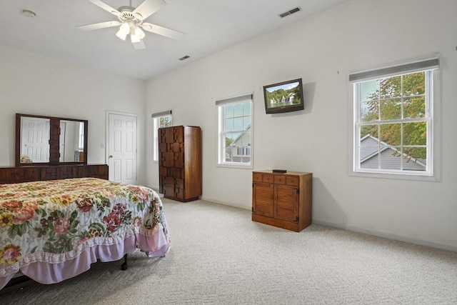 bedroom with carpet flooring, multiple windows, baseboards, and a ceiling fan