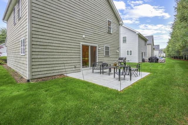 rear view of house featuring a yard and a patio area