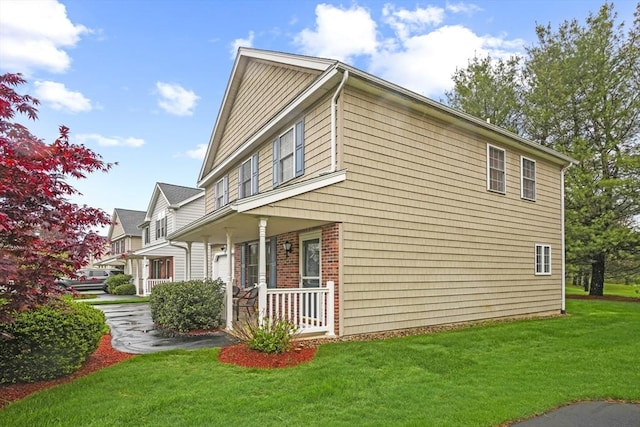 view of property exterior with a porch and a yard