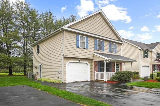 view of front of house featuring a porch, central air condition unit, an attached garage, and driveway