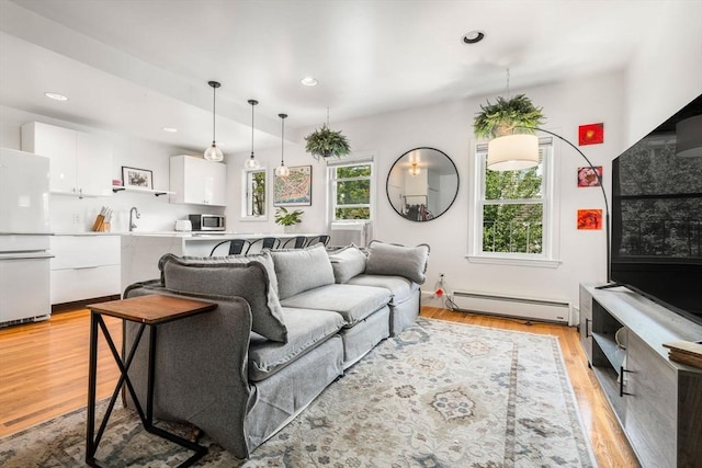 122 W 9th St Unit 2, Boston, MA 02127 - living room with a baseboard heating unit, light wood-type flooring, and recessed lighting