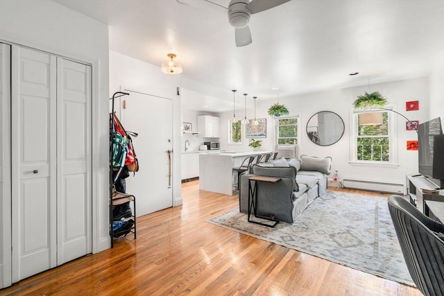 122 W 9th St Unit 2, Boston, MA 02127 - living room with a baseboard heating unit, ceiling fan, light wood-style flooring, and recessed lighting