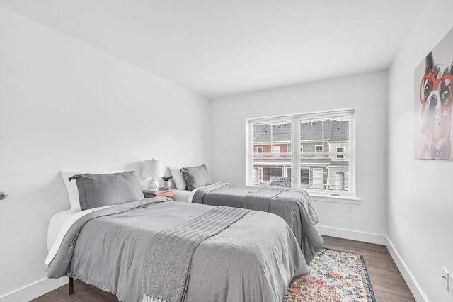 bedroom with dark hardwood / wood-style flooring