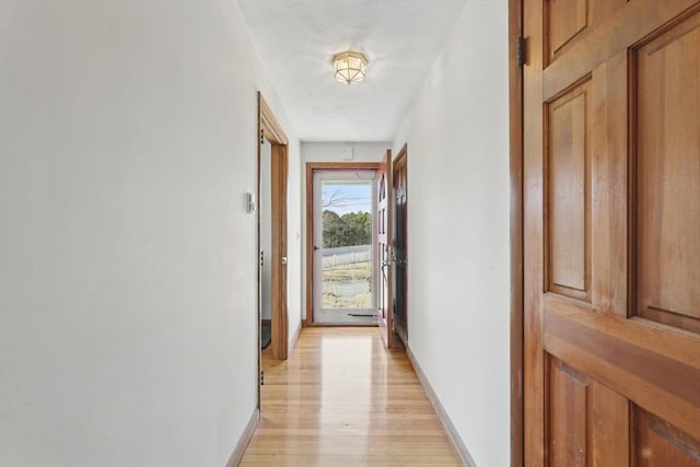 entryway featuring baseboards and light wood-type flooring