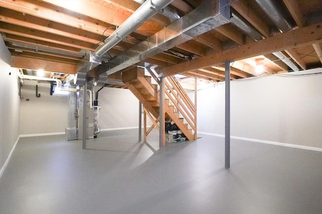 unfinished basement featuring stairway and baseboards