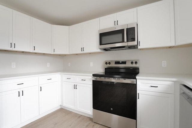 kitchen featuring light wood-style floors, appliances with stainless steel finishes, white cabinets, and light countertops