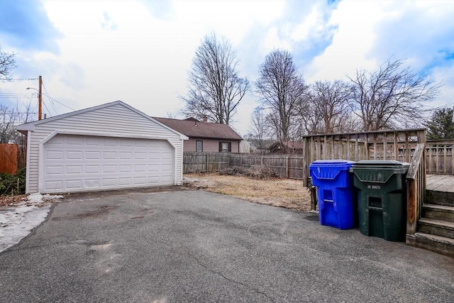 detached garage featuring fence