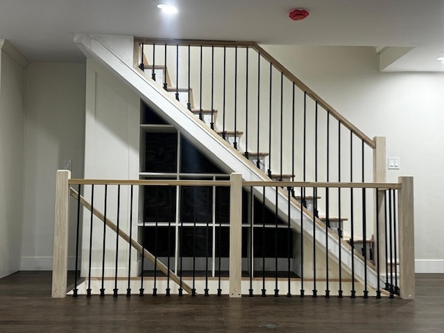 stairway with hardwood / wood-style floors