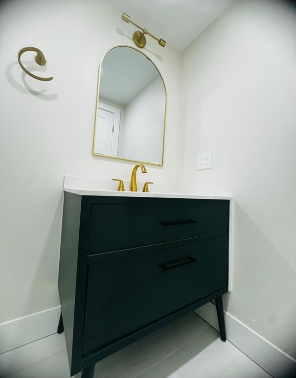 bathroom featuring tile patterned flooring and vanity